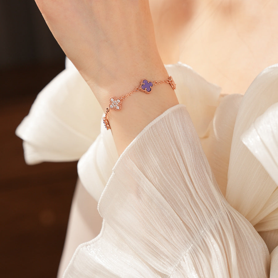 Detailed view of violet enamel clover and rhinestone motifs on Glazenya bracelet