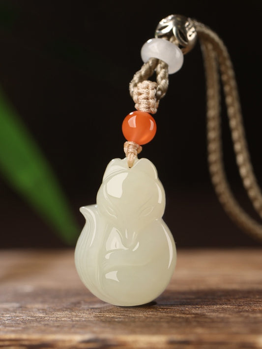 Hand-carved Hetian jade fox pendant on braided cord — Peach Blossom Hetian Jade Fox Pendant