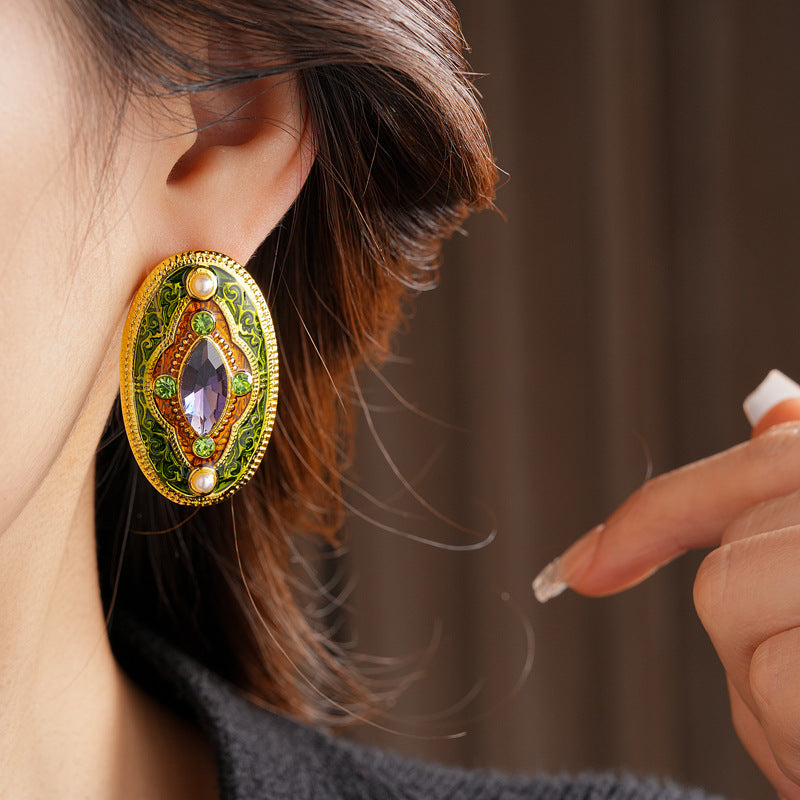 Antique-gold oval earrings with marquise purple crystal, olive rhinestones, and pearl accents — Byzantine Marquise Pearl Oval Earrings.