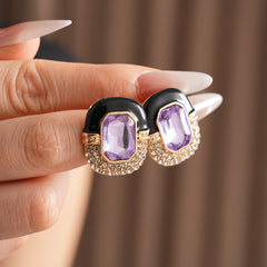 Black enamel stud earrings with amethyst-tone crystal and rhinestone frame — Midnight Amethyst Radiance Earrings.