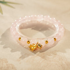 Natural amethyst beaded bangle with gold-tone accents and a lucky charm (Floral or Gourd) — Violet Fortune Amethyst Bangle.