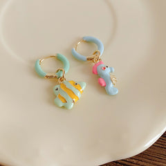 Pastel enamel huggie earrings with mismatched seahorse and striped fish charms — Seafoam Mismatch Ocean Charm Huggies.