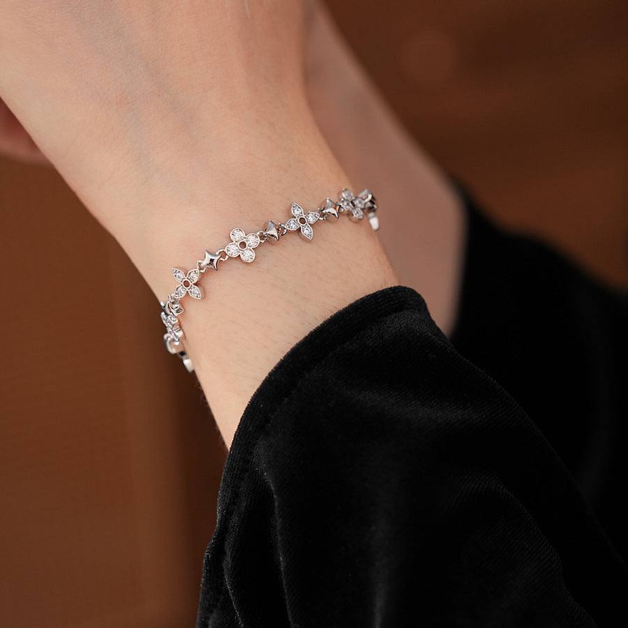 Radiant Flora Bracelet with zircon-studded floral and star motifs on dark blue box – Glazenya jewelry