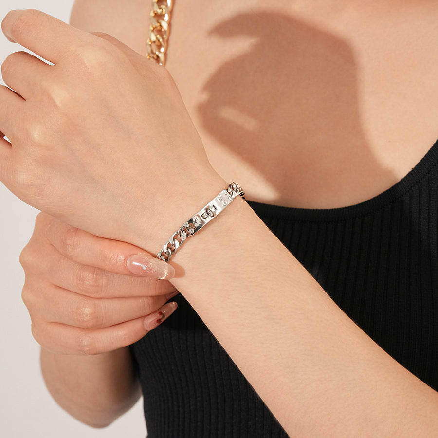 LockChain Minimalist Bracelet in silver, gold, and black metal chain with lock clasp design, displayed on wrist