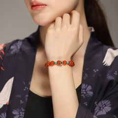Collectible-grade Hetian jade bracelet with high-ice red agate centerpiece and turquoise accents — Crimson Serenity Hetian Jade Bracelet.