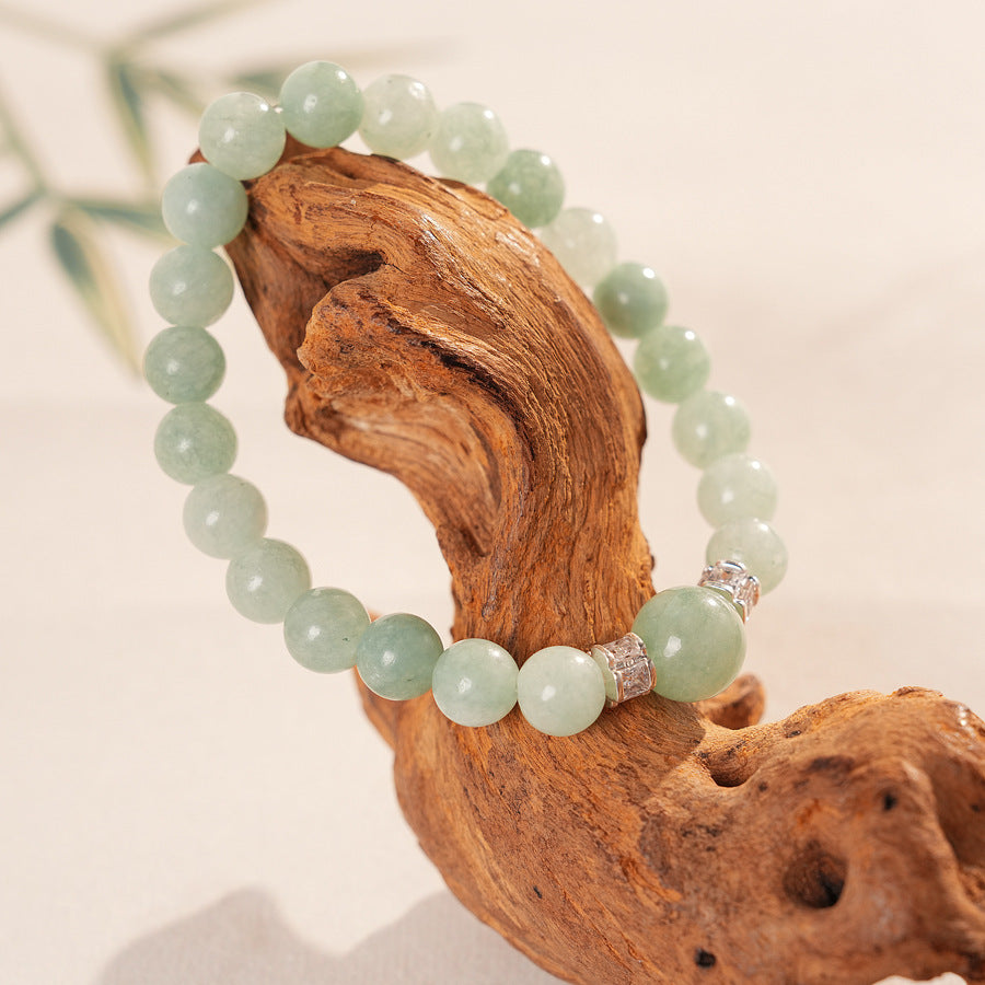 A fresh light green round bead bracelet with two silver zircon spacer beads and a large main bead - Celadon Serenity Bracelet.