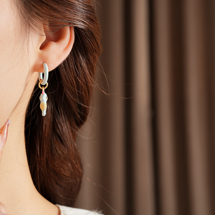 Pastel enamel huggie earrings with mismatched seahorse and striped fish charms — Seafoam Mismatch Ocean Charm Huggies.