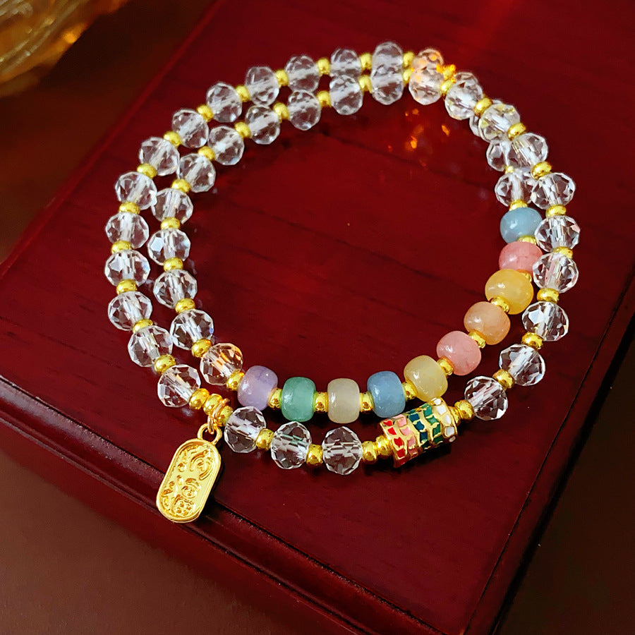 Double-layer dopamine crystal bracelet with clear crystals and colorful stone beads on green velvet background