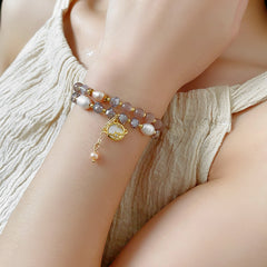 Celestial Cat’s Eye Bracelet double strand with cat’s-eye stones, freshwater pearls, crystal beads and gold planet charm