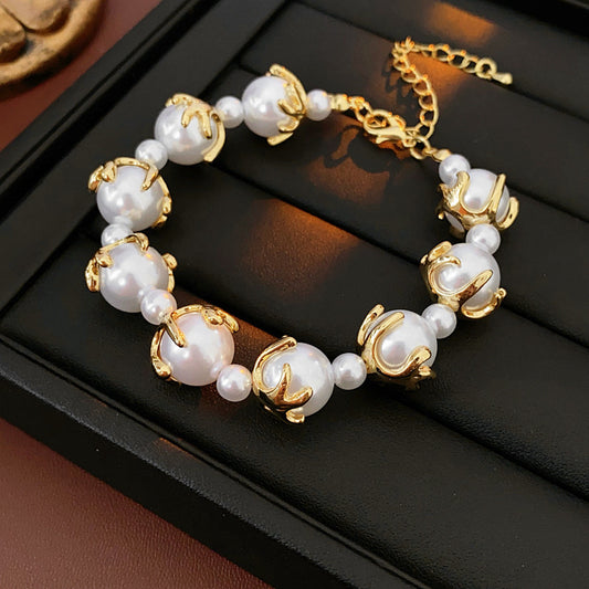 Fleur de Lumière Pearl Set with golden petal-claw settings on pearls, necklace and bracelet