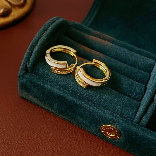 Gold huggie hoop earrings with ivory enamel arc and baguette CZ row — Luna Arc Enamel Baguette Huggies.