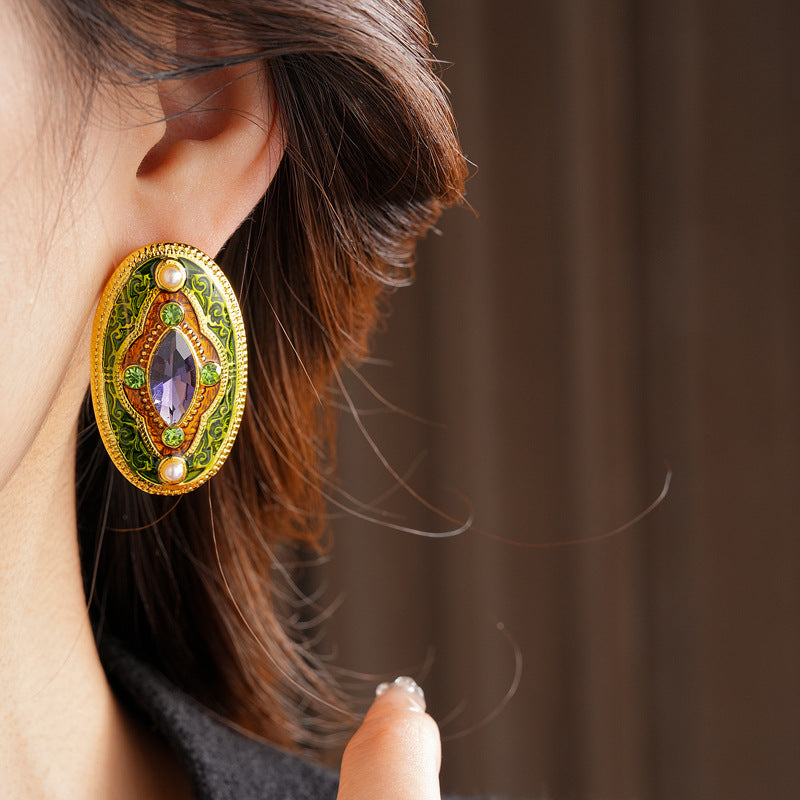 Antique-gold oval earrings with marquise purple crystal, olive rhinestones, and pearl accents — Byzantine Marquise Pearl Oval Earrings.