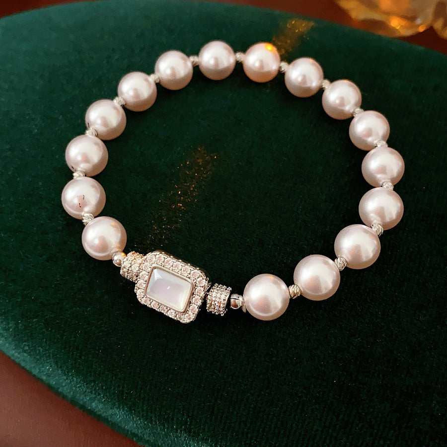 Deco Halo Pearl Bracelet featuring luminous pearls and a pavé-framed rectangular mother-of-pearl charm.