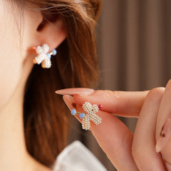 Balloon dog stud earrings crafted from imitation pearls with blue bead details — Playful Poodle Pearl Studs.