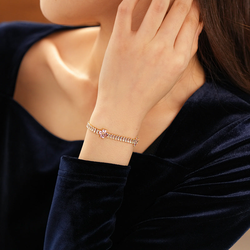 Petal Sparkle Tennis Bracelet lineup in gold and silver with pink and blue accents – baguette zircon floral design