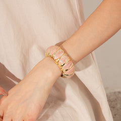 Gold-tone segmented bangle with marbled acrylic dome tiles — Gilded Capsule Resin Bangle.