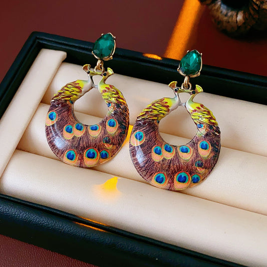 Statement earrings with peacock feather hoop design and emerald stud – Peacock Glory Statement Earrings.