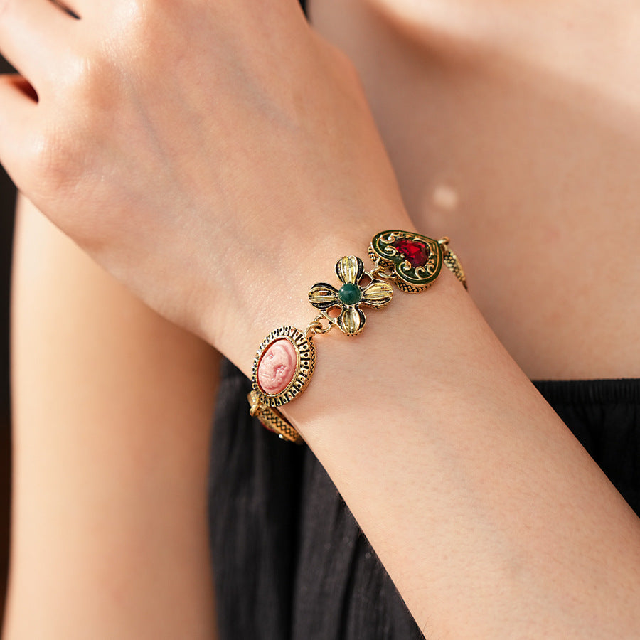 Royal Garden Cameo Set with gold-tone floral links, pink cameo ovals, green enamel hearts, and red stones